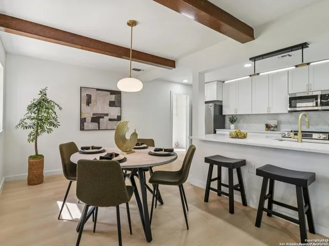 a kitchen with stainless steel appliances a stove sink microwave and cabinets