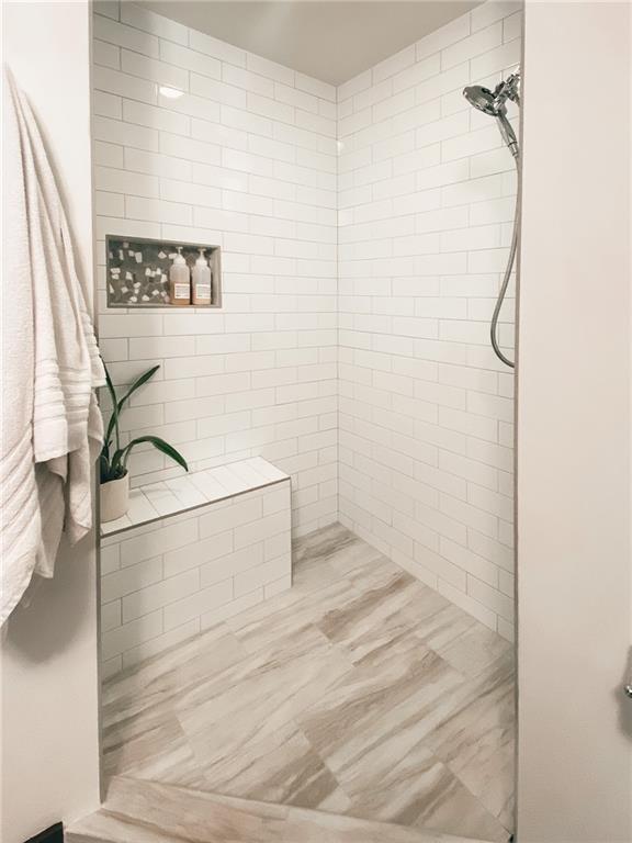 747 Ralph McGill Boulevard Northeast, Unit 217 Atlanta, GA 30312 - Photo 14 of 28 a bathroom with a bathtub and shower