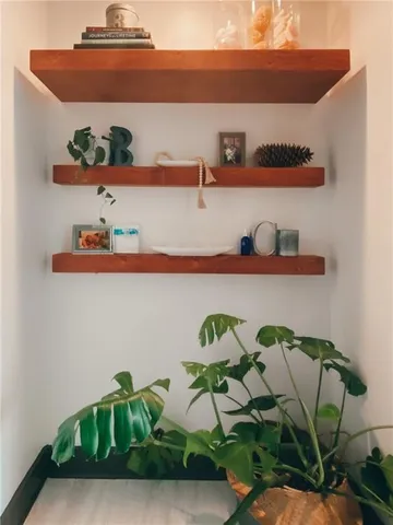 a living room with furniture a window and a potted plant
