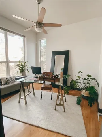a living room with furniture and a wooden floor