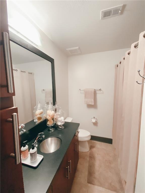 747 Ralph McGill Boulevard Northeast, Unit 217 Atlanta, GA 30312 - Photo 19 of 28 a bathroom with a sink and mirror with toilet