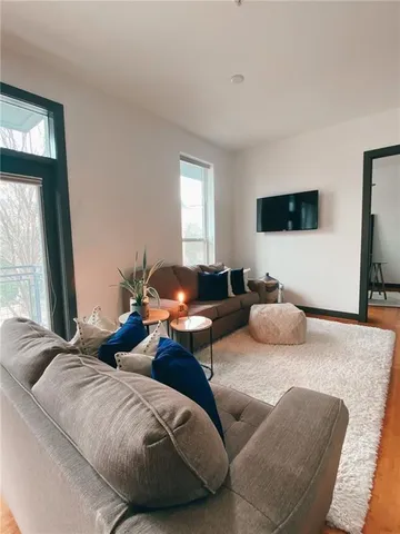 a living room with couches and a flat screen tv