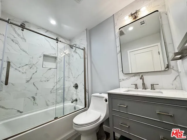 a bathroom with a toilet sink and shower