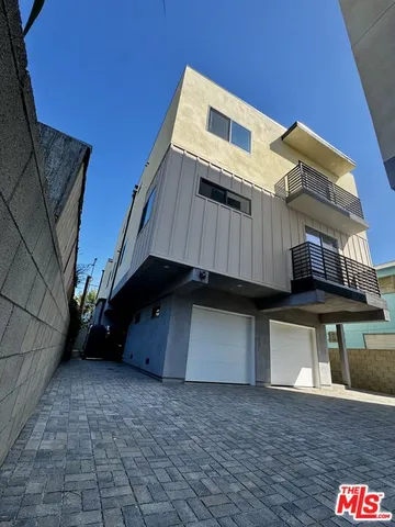 a view of a house with a wooden deck