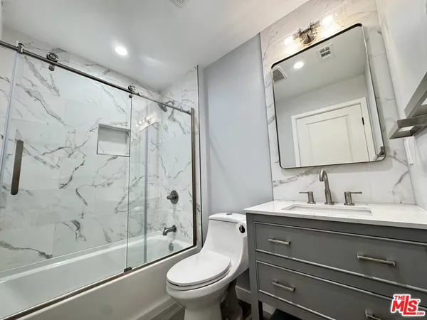 a bathroom with a toilet sink and shower