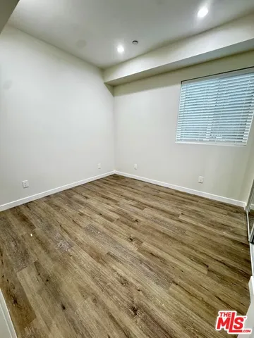 an empty room with wooden floor