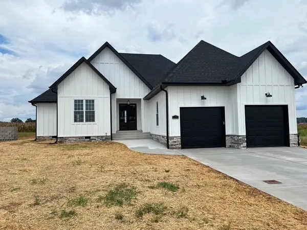 a view of a house with a yard and garage