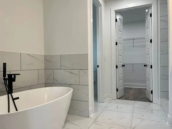 a bathroom with a tub and shower