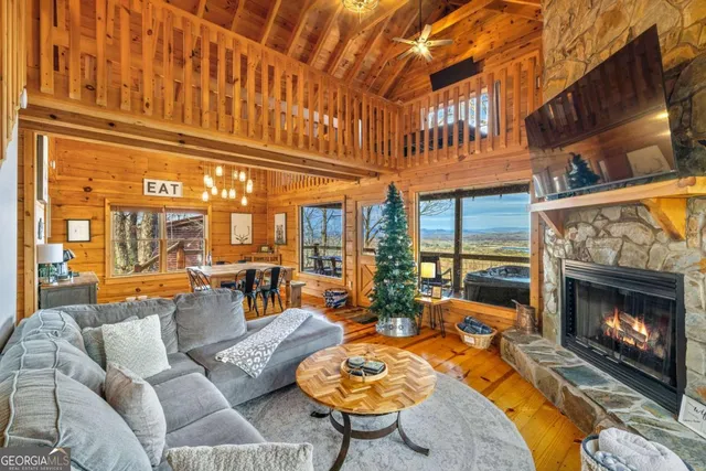 a living room with furniture a rug and a fireplace