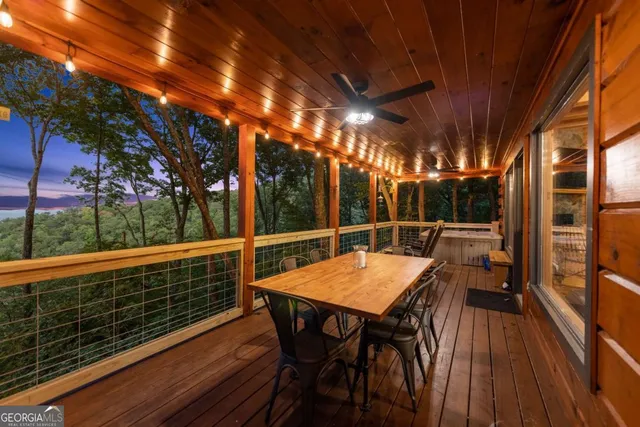 a view of a patio with table and chairs and floor to ceiling window