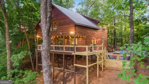 a pathway of a house and a yard with green space and fountain