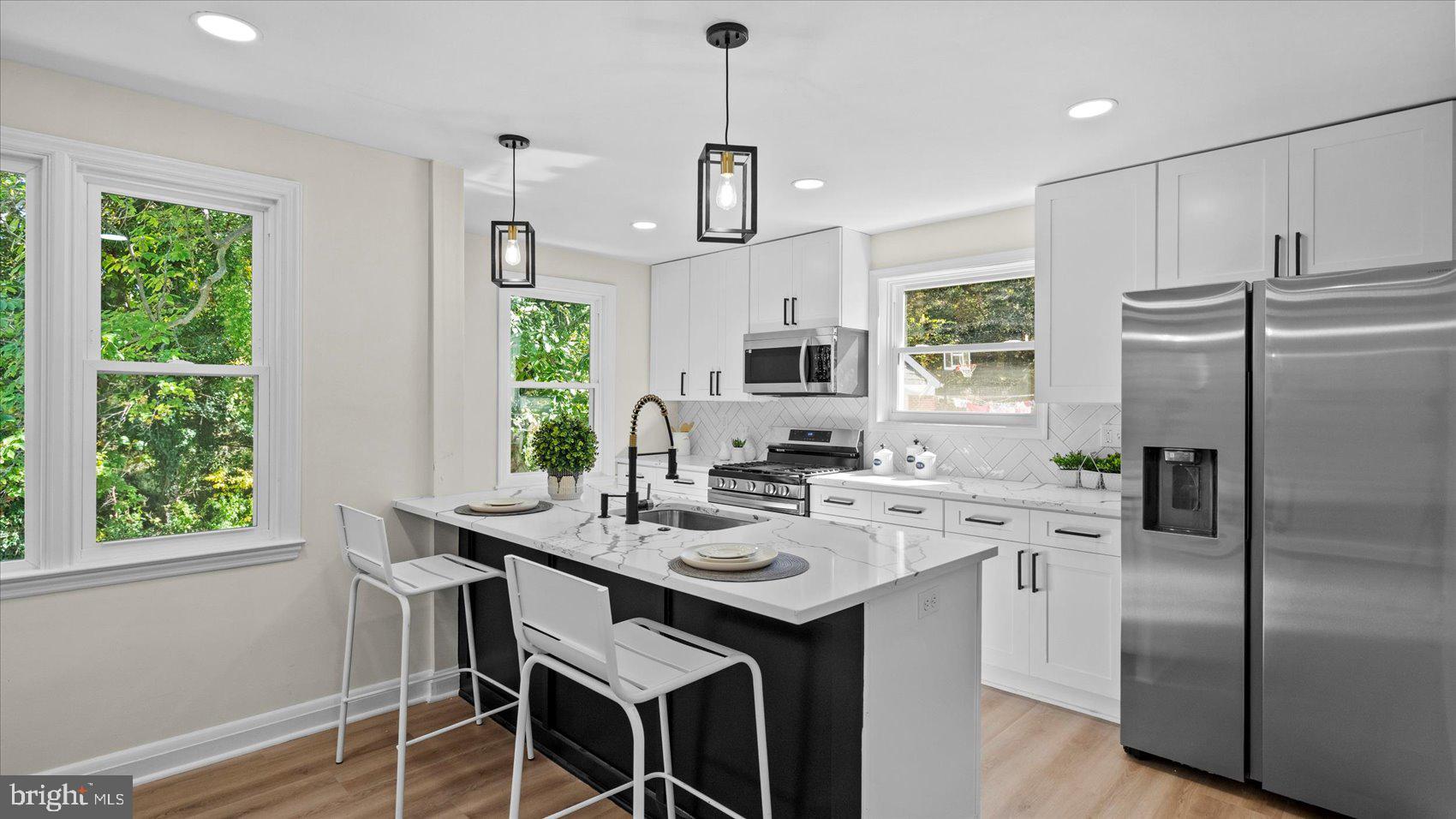 711 West Hills Road Baltimore, MD 21229 - Photo 15 of 52 a kitchen with stainless steel appliances granite countertop a sink a stove a refrigerator cabinets and a dining table