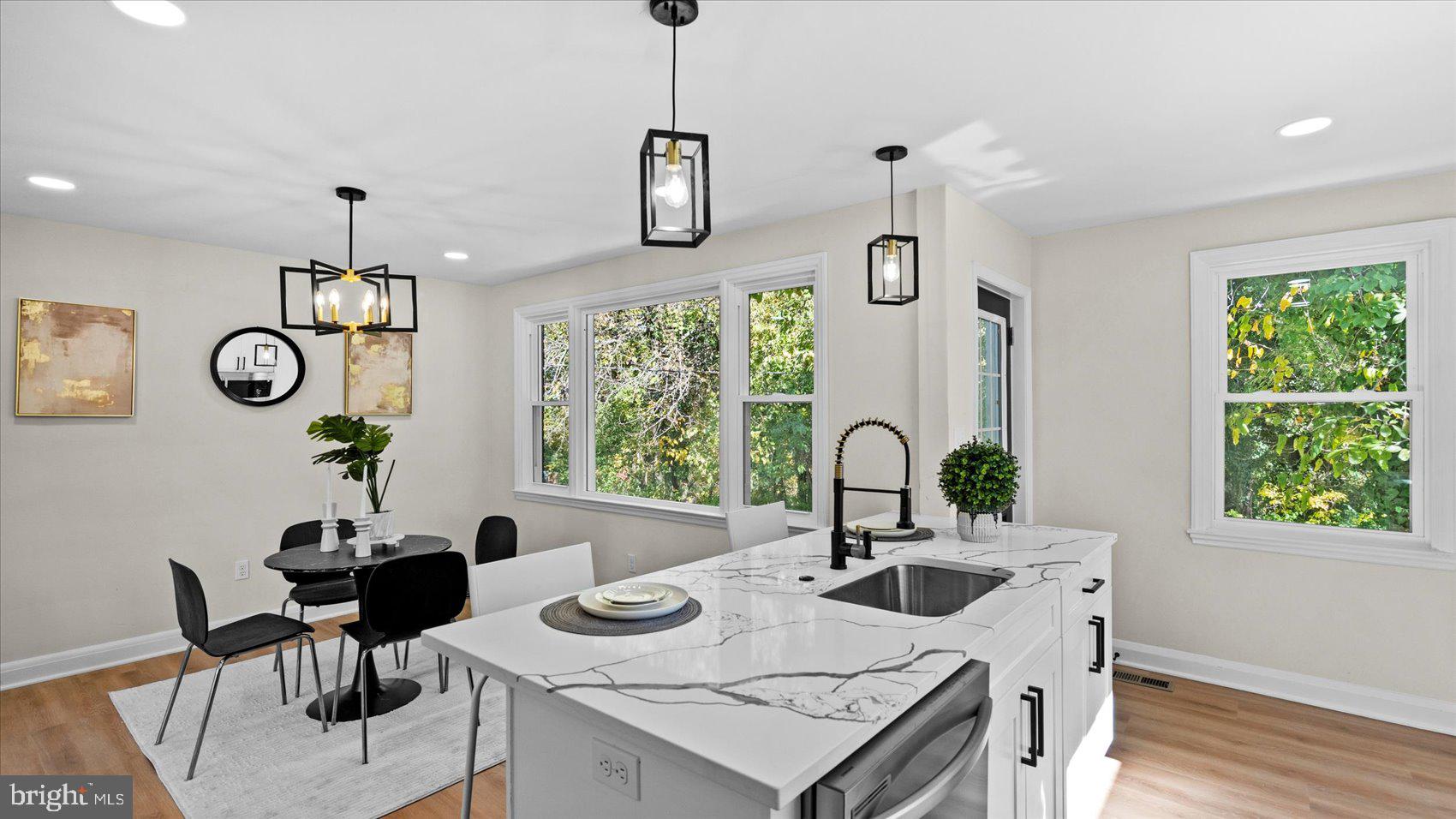 711 West Hills Road Baltimore, MD 21229 - Photo 17 of 52 a kitchen with a table chairs and a dining table