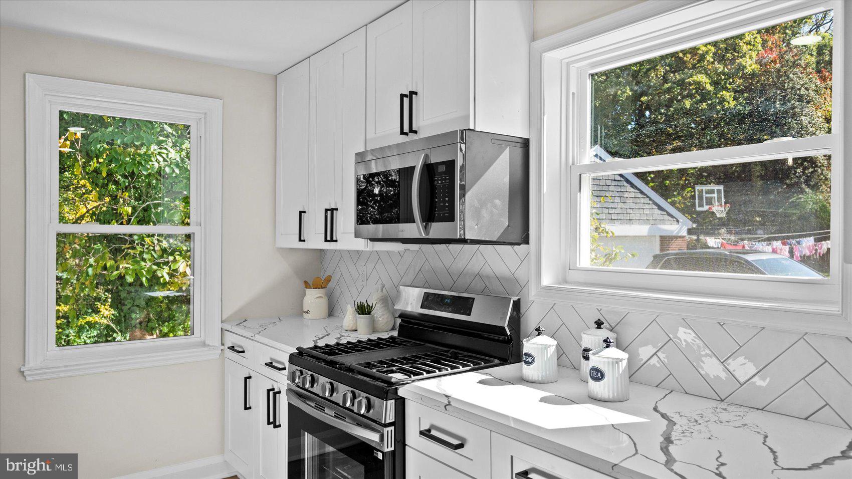 711 West Hills Road Baltimore, MD 21229 - Photo 19 of 52 a kitchen with a stove a sink and a window
