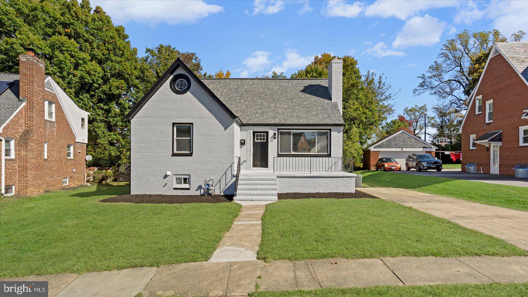 711 West Hills Road Baltimore, MD 21229 - Photo 3 of 52 a front view of a house with a garden and yard