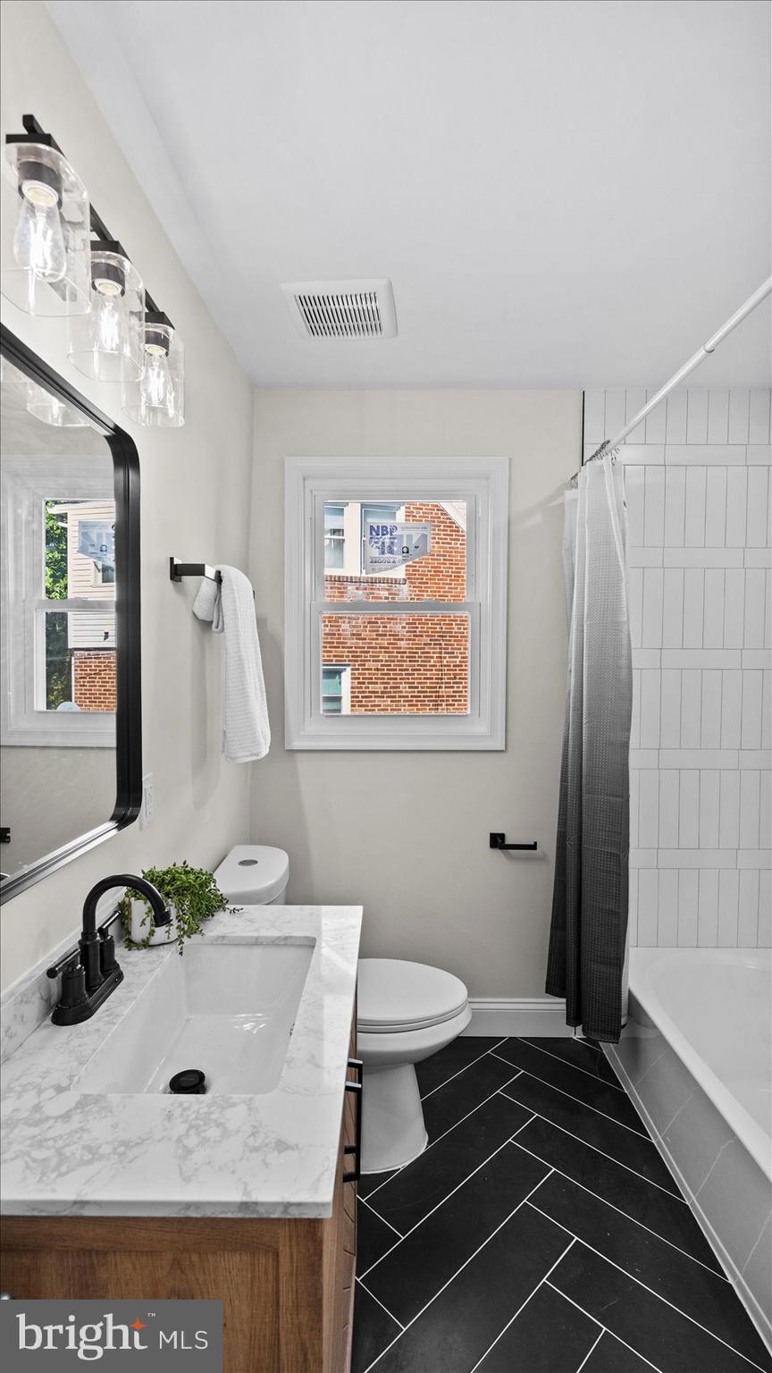 711 West Hills Road Baltimore, MD 21229 - Photo 33 of 52 a bathroom with a sink and a mirror