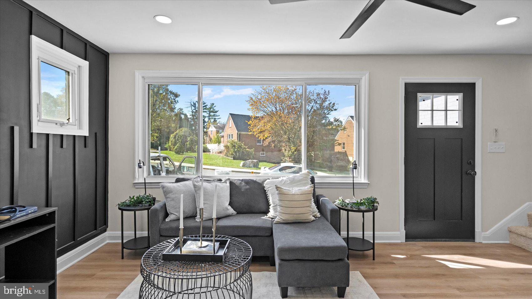 711 West Hills Road Baltimore, MD 21229 - Photo 8 of 52 a living room with furniture and a floor to ceiling window