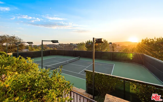 a living room with a fireplace furniture a rug and a fireplace