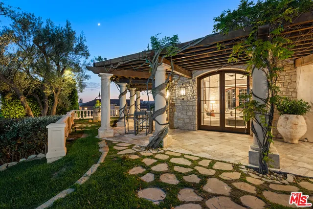 a kitchen with granite countertop cabinets and chairs