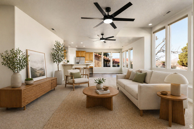 2158 Balboa Way St. George, UT 84770 - Photo 5 of 40 VIRTUALLY Staged. Living area featuring ceiling fan, recessed lighting, and light carpet