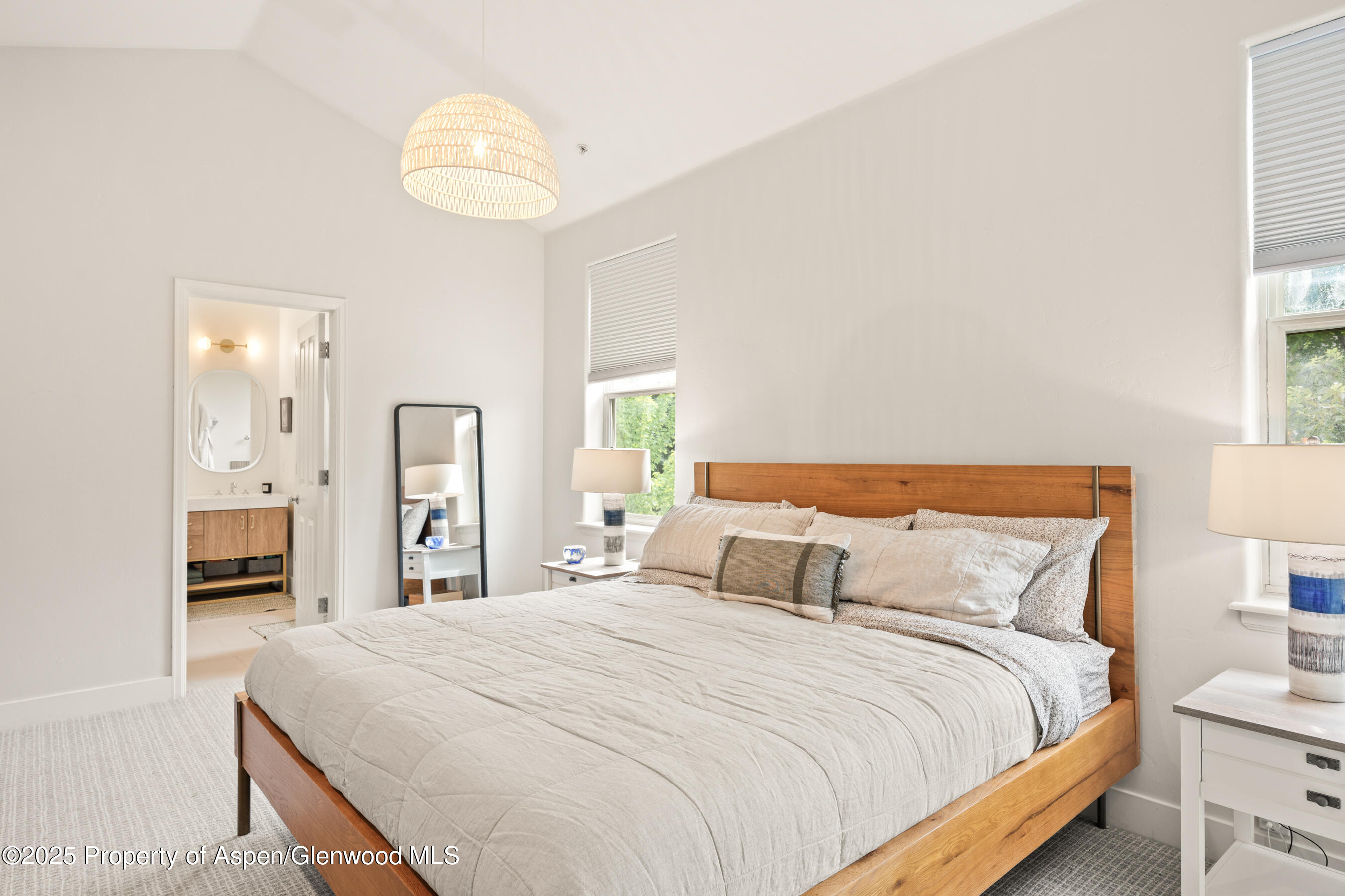 545 Evans Court Basalt, CO 81621 - Photo 11 of 25 a bedroom with a bed and a chandelier