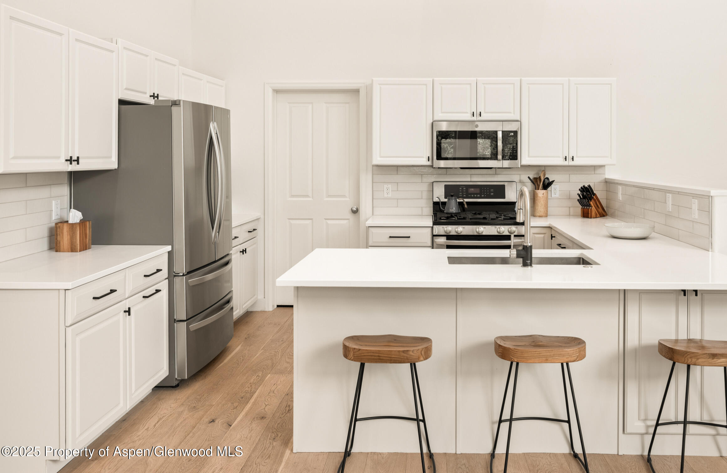 545 Evans Court Basalt, CO 81621 - Photo 5 of 25 a kitchen with stainless steel appliances a stove refrigerator sink and cabinets