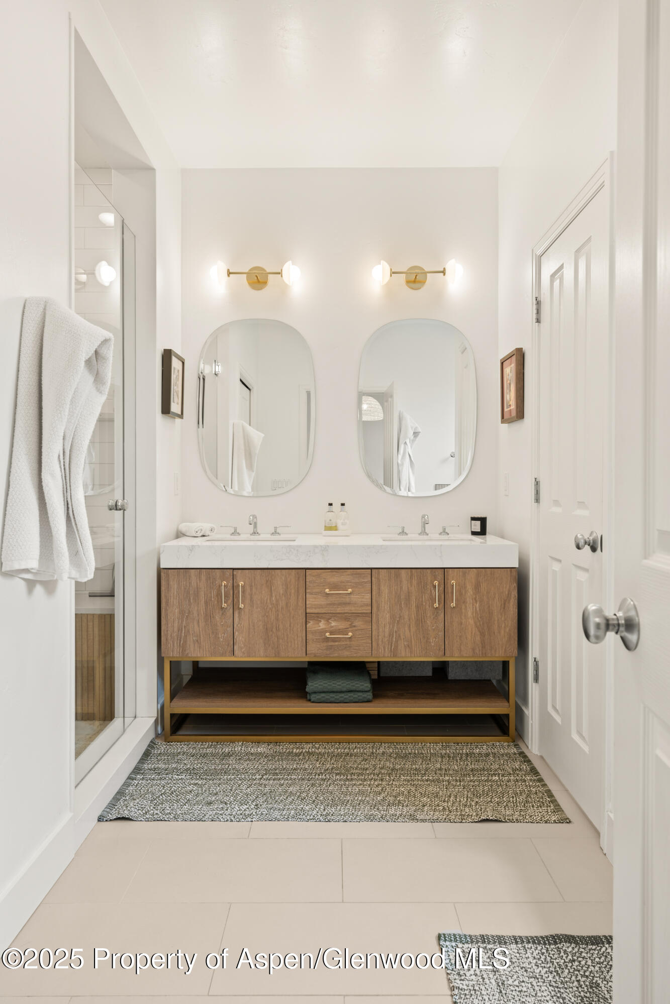 545 Evans Court Basalt, CO 81621 - Photo 10 of 25 a bathroom with a tub a double vanity sink and a mirror