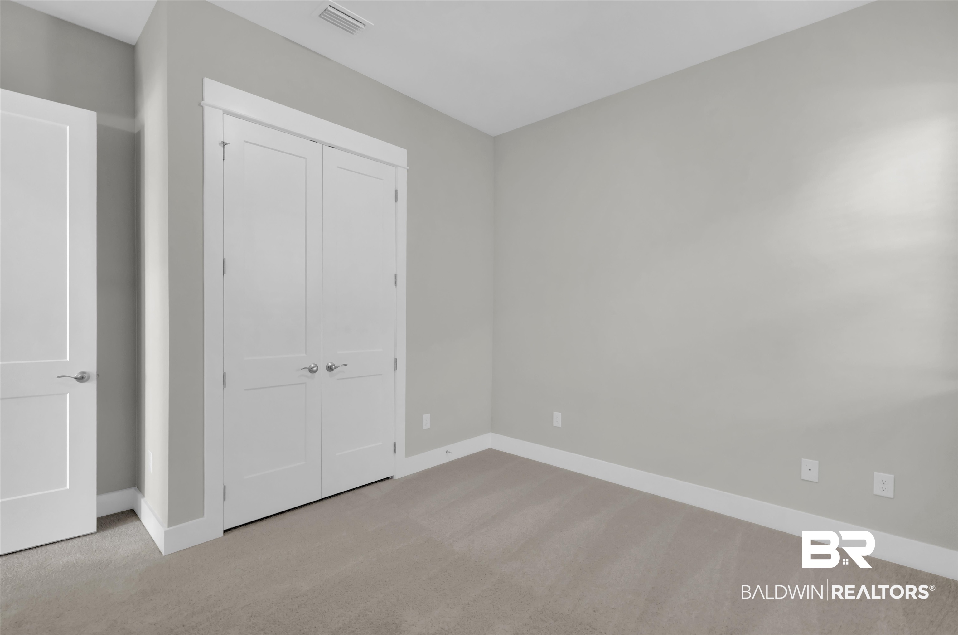 571 Morning Mist Way Fairhope, AL 36532 - Photo 28 of 47 Unfurnished bedroom featuring light carpet and a closet