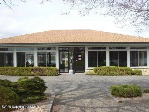 a view of a swimming pool with a lawn chairs