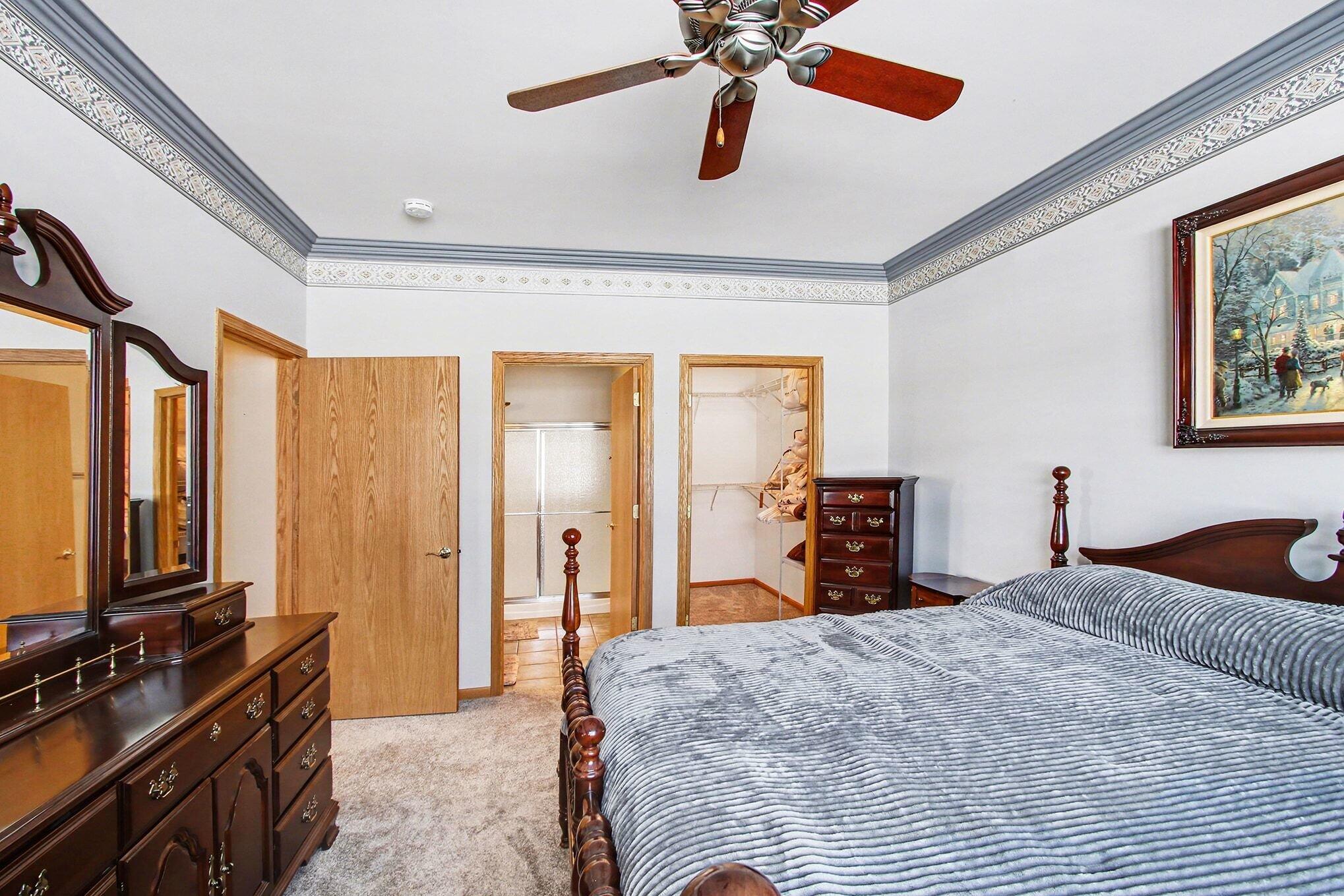 12310 80th Place Dyer, IN 46311 - Photo 17 of 37 a bedroom with a bed and a chandelier