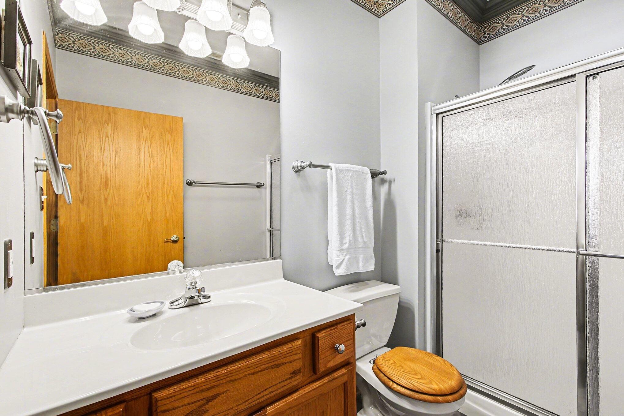 12310 80th Place Dyer, IN 46311 - Photo 18 of 37 a bathroom with a granite countertop sink toilet and a mirror