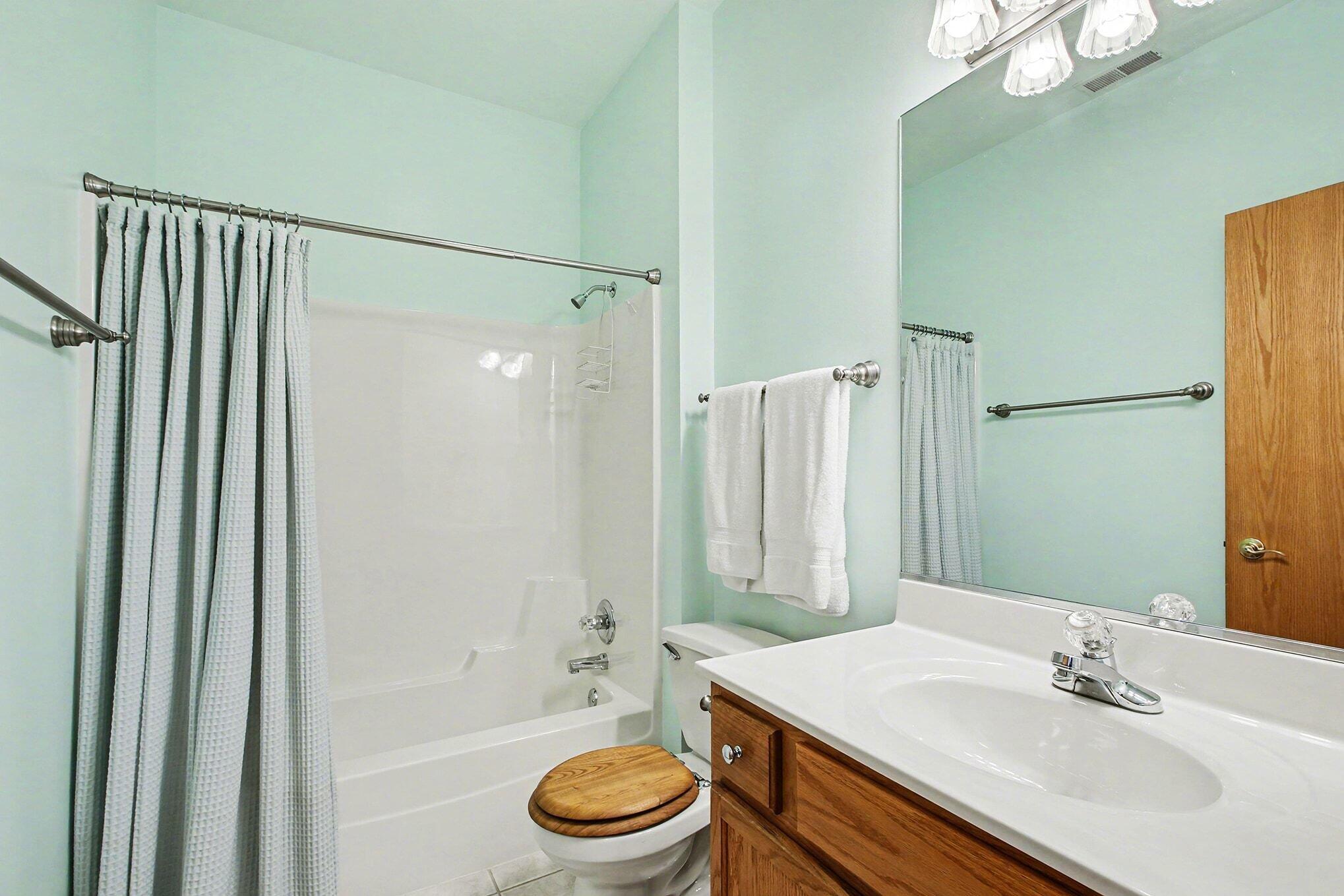 12310 80th Place Dyer, IN 46311 - Photo 21 of 37 a bathroom with a sink a toilet a mirror and shower