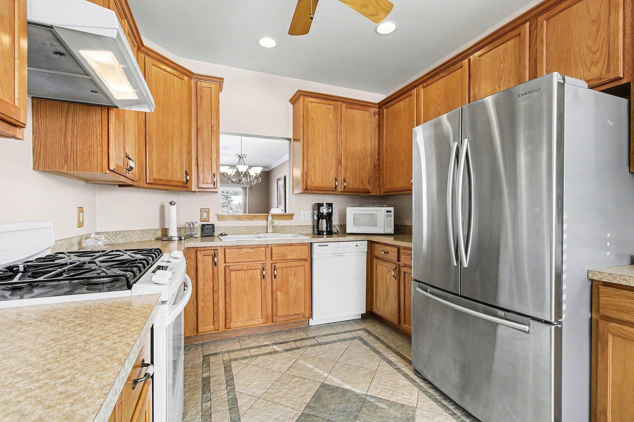 12310 80th Place Dyer, IN 46311 - Photo 9 of 37 a kitchen with stainless steel appliances granite countertop a refrigerator stove and a sink