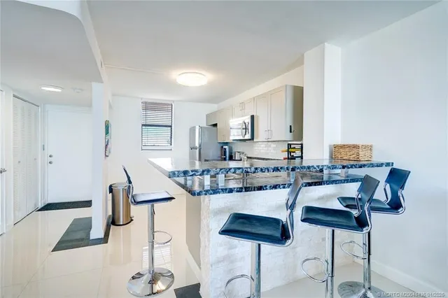 a kitchen with cabinets table and chairs