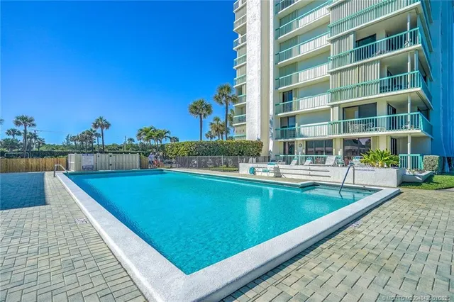 a wooden bench sitting in backside of a house