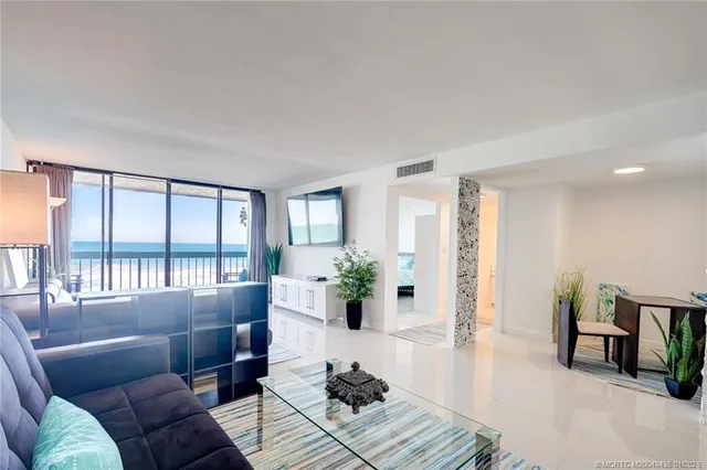 a living room with furniture or couch and a potted plant