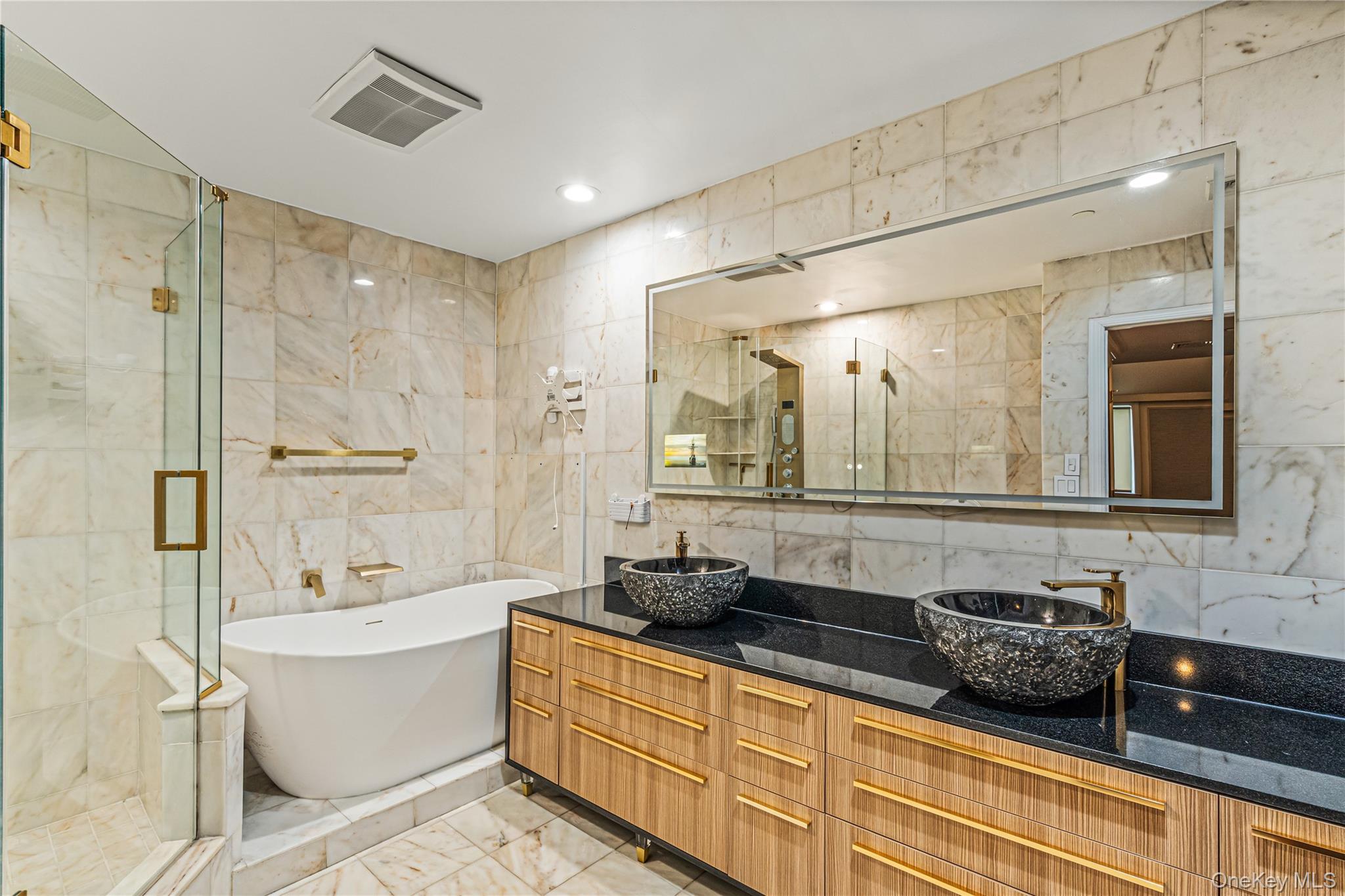 171 Great Neck Road, Unit 4R Great Neck, NY 11021 - Photo 11 of 27 a bathroom with a double vanity sink a large mirror and shower