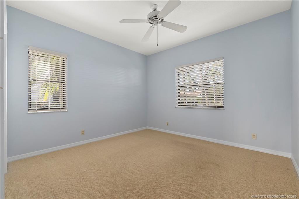 6122 Southeast Landing Way, Unit 4 Stuart, FL 34997 - Photo 12 of 23 an empty room with a window and ceiling fan
