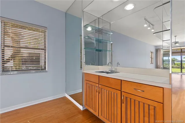 a bathroom with a sink a vanity and a large mirror