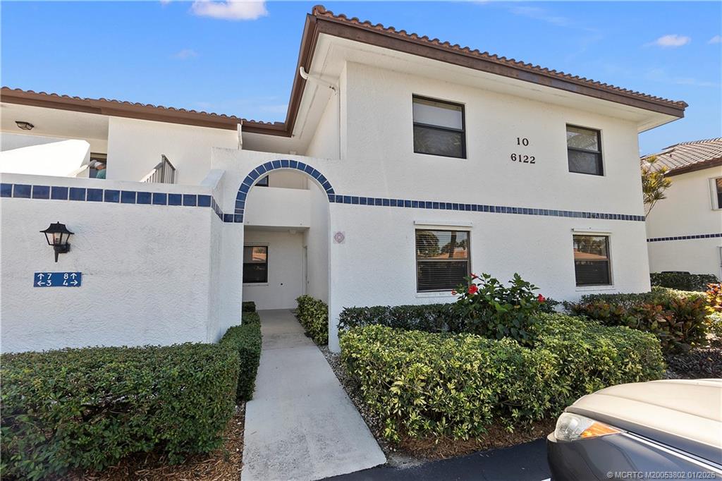 6122 Southeast Landing Way, Unit 4 Stuart, FL 34997 - Photo 2 of 23 a front view of a house with a yard