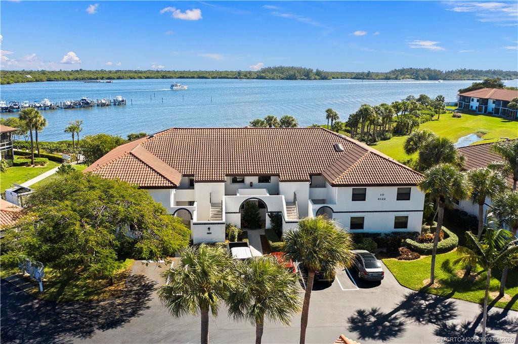6122 Southeast Landing Way, Unit 4 Stuart, FL 34997 - Photo 21 of 23 an aerial view of a house with outdoor space and lake view