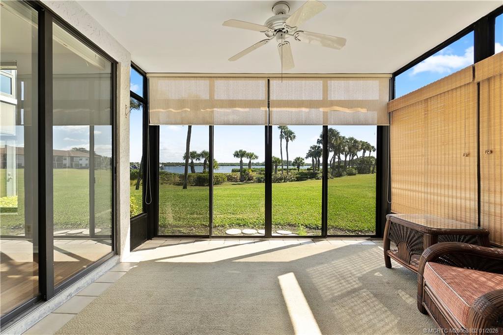 6122 Southeast Landing Way, Unit 4 Stuart, FL 34997 - Photo 8 of 23 a living room with hardwood floor and balcony view