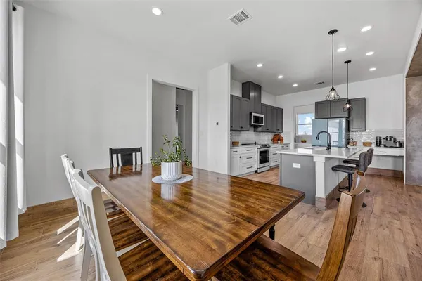 a dining room with furniture and wooden floor