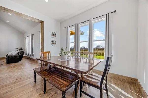a dining room with furniture and wooden floor