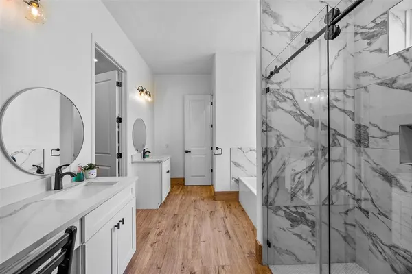 a spacious bathroom with a sink and a mirror