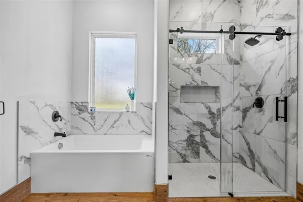 a bathroom with a bathtub and shower