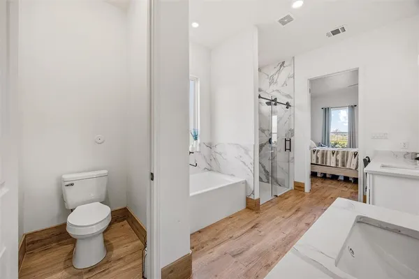 a spacious bathroom with a bathtub toilet and a shower