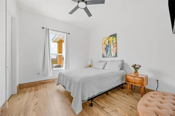 a bedroom with a bed and a window