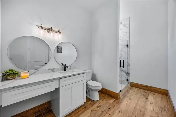 a bathroom with a toilet a sink and mirror