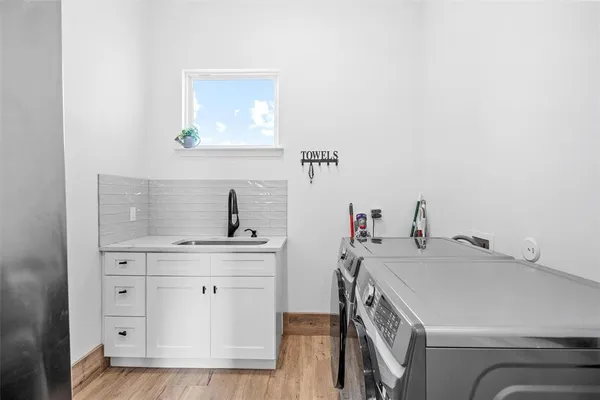 a utility room with sink dryer and washer
